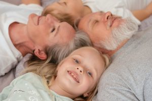 Grandparents lay down with their grandchildren